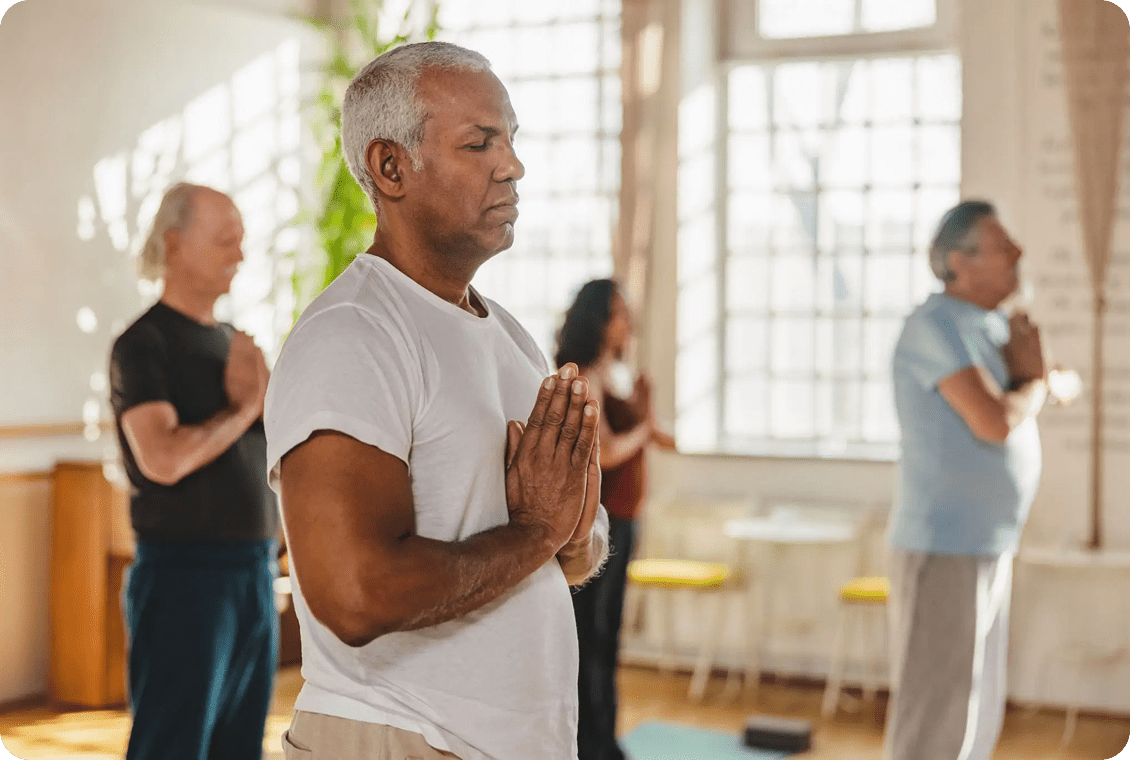 Group practicing meditation indoors